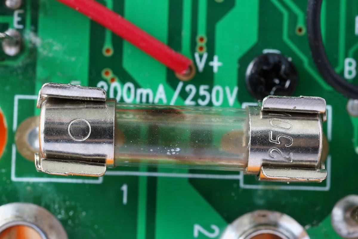 Blown defective fuseinstalled on electronic green circuit board