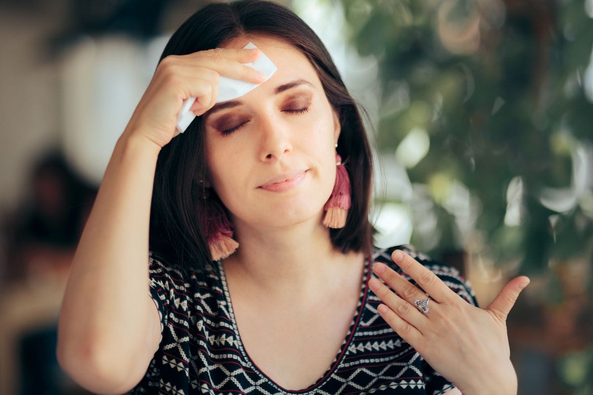 Woman Feeling Hot During Summer Wiping Her Forehead