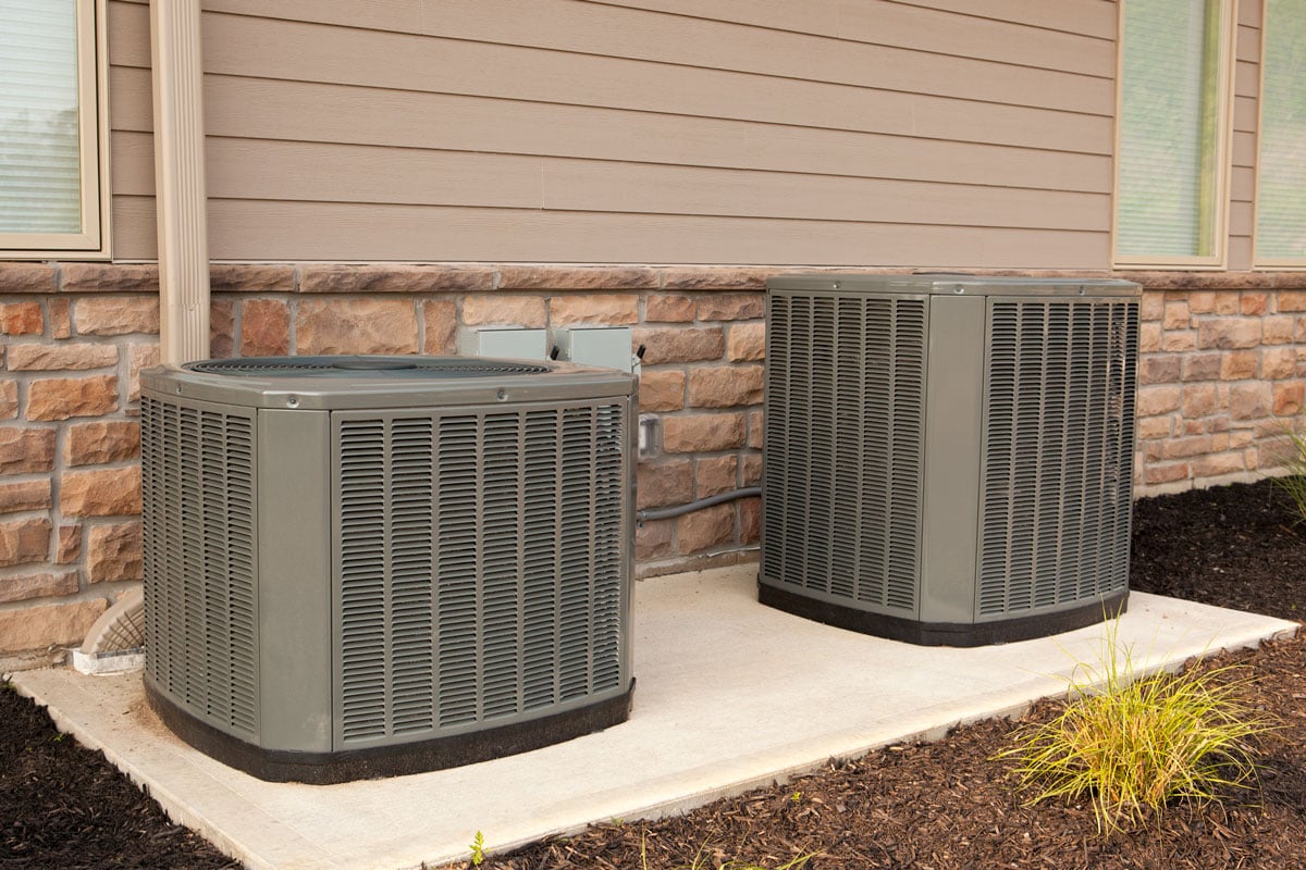 Gray concrete air conditioning units on concrete slabs