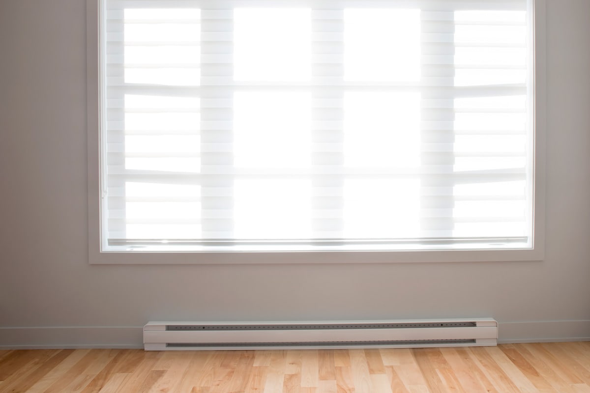 Interior of an empty living room with a baseboard heater