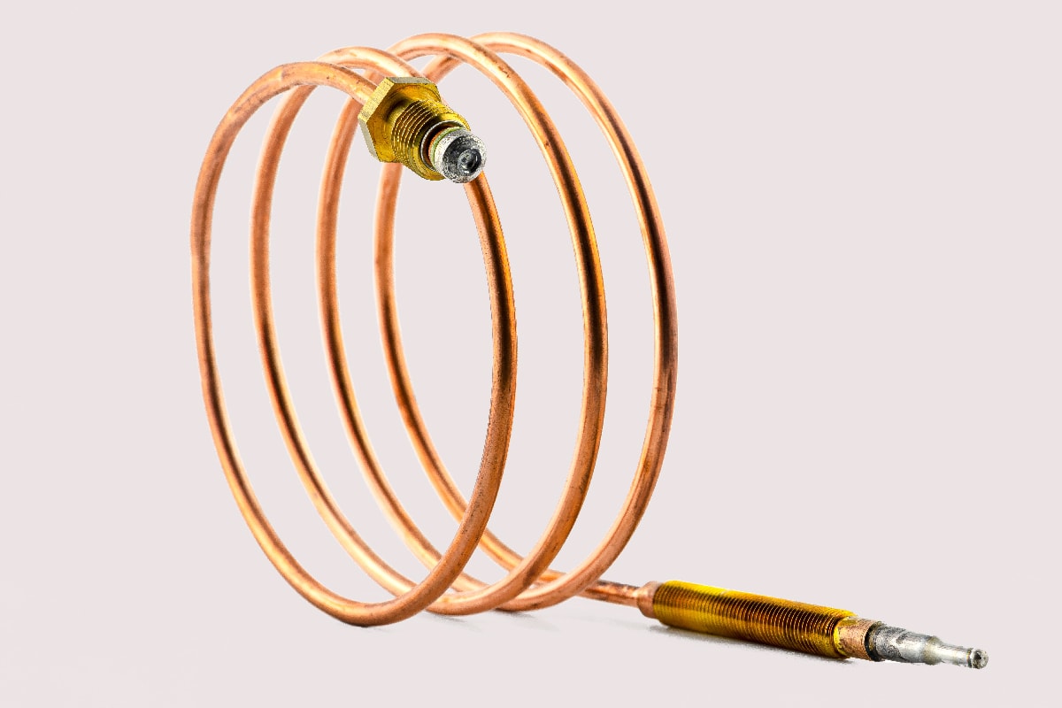 Macro photo of a temperature probe made of copper in the shape of a spiral with threaded tips