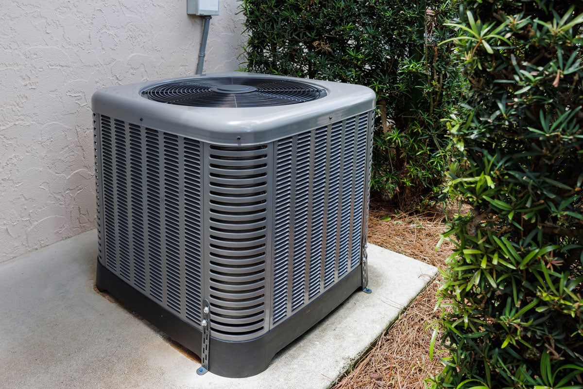 Modern HVAC air conditioner unit on concrete slab outside of house Payne Type Ac