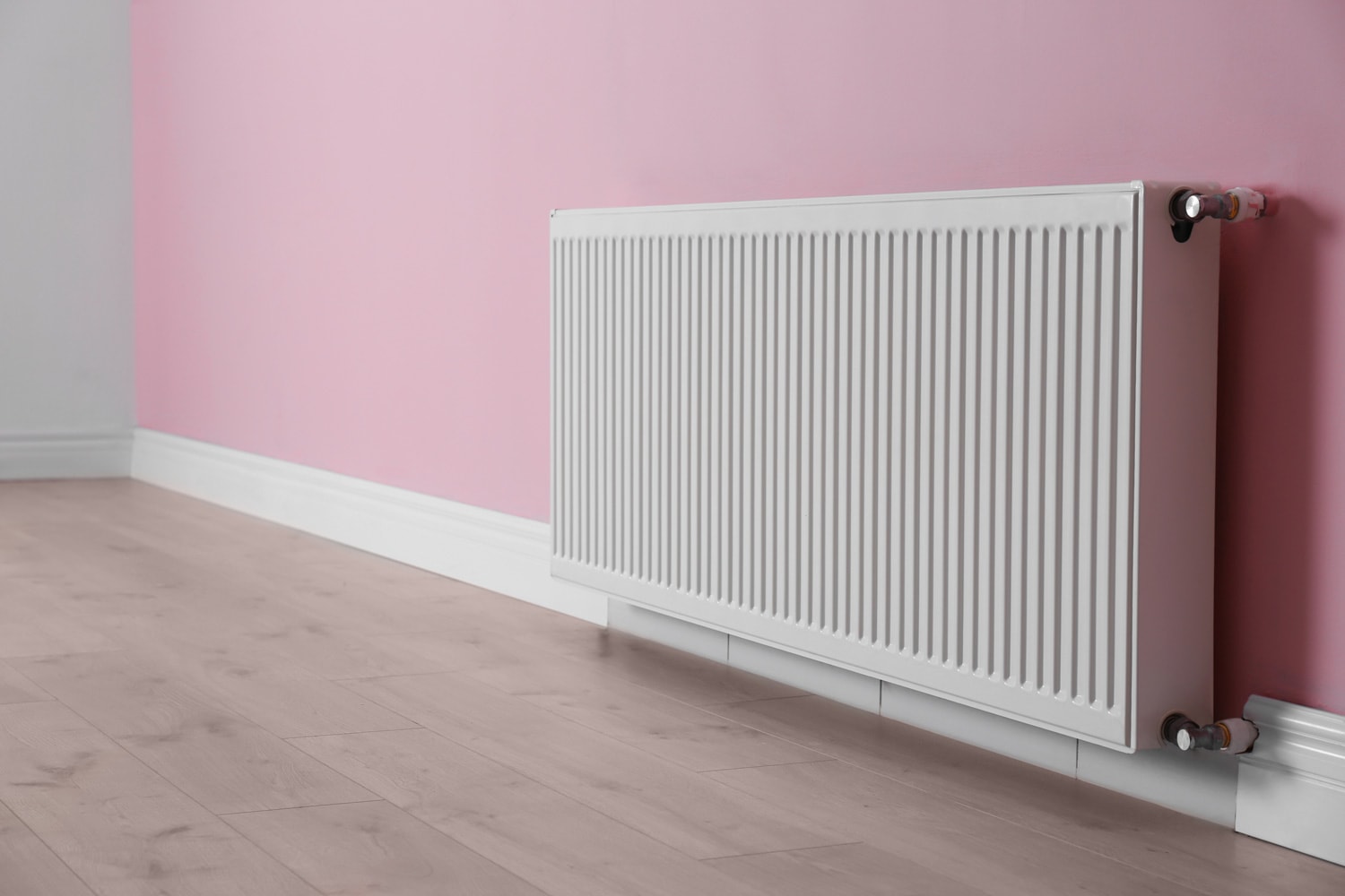 Modern radiator on color wall indoors. Central heating system