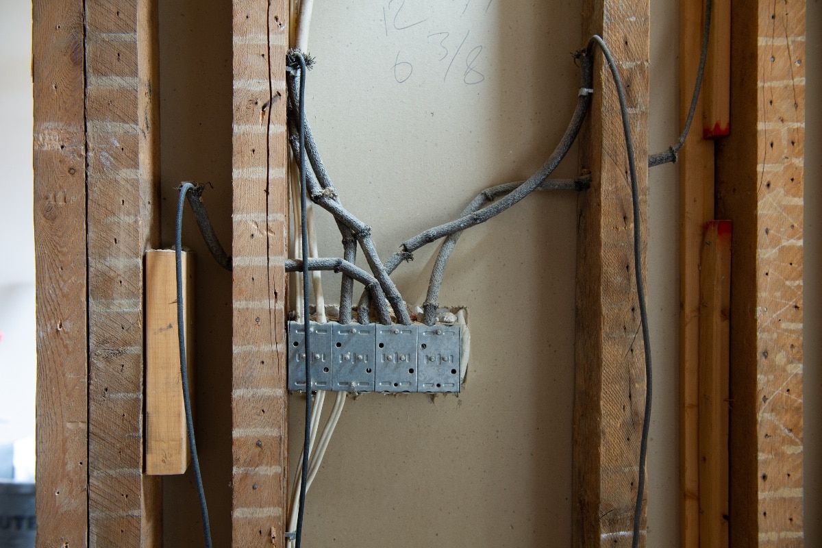 Numerous Incorrect Modifications - Electrical wires, Knob-and-tube, on a residential renovation site.