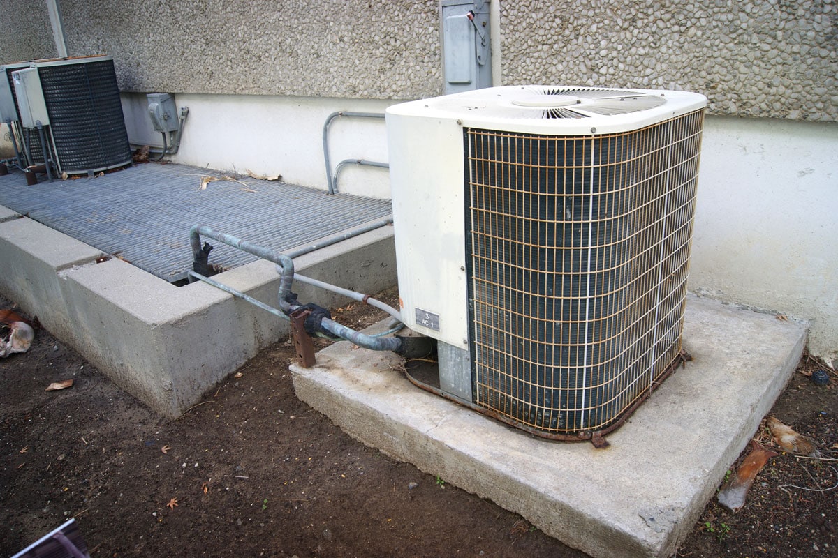 Old white heat pump for a small residential house