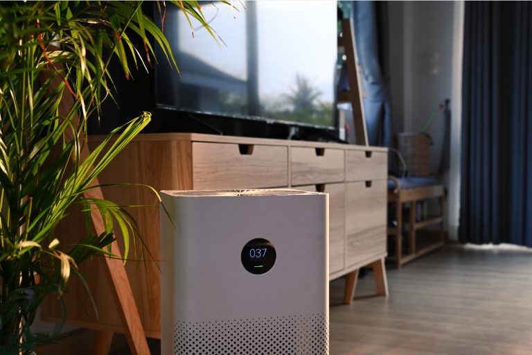 A portable air purifier on wooden floor in comfortable home, Honeywell Air Purifier Burning Smell - What Could Be Wrong?