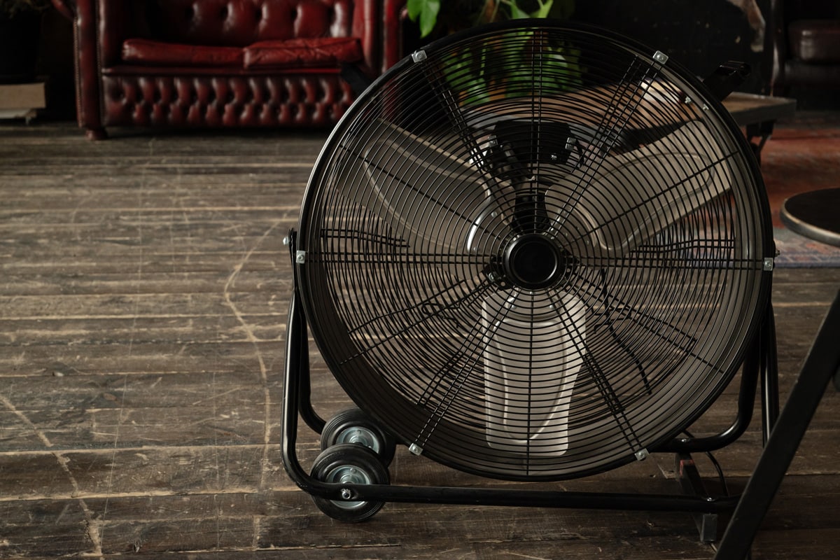 Round cooling fan on the wooden floor in room 
