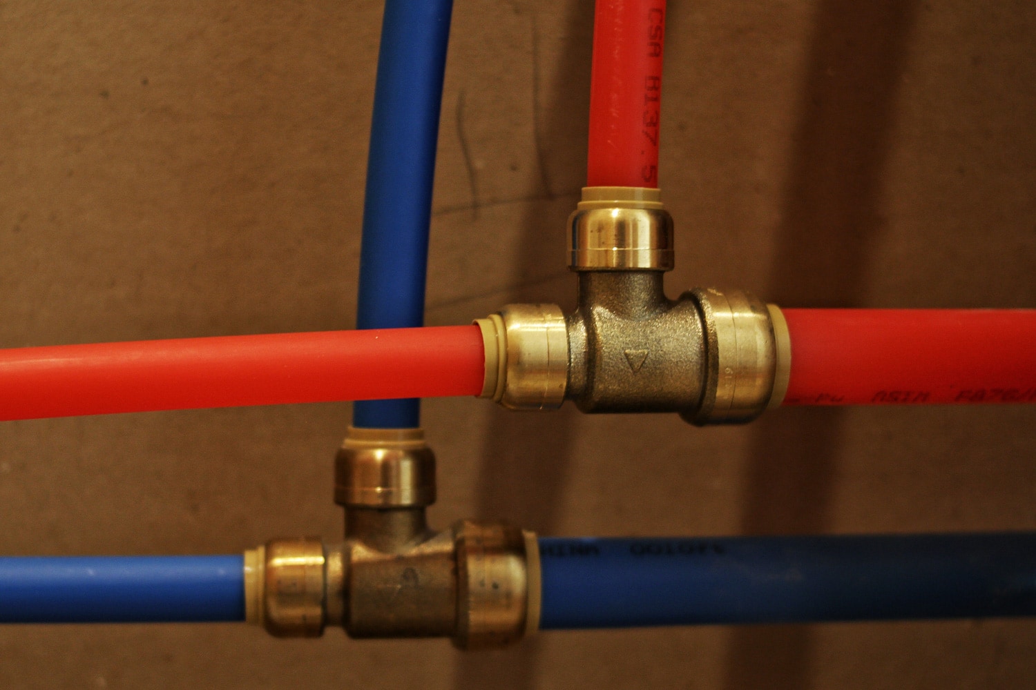 Sharkbite fittings with red and blue PEX pipe.