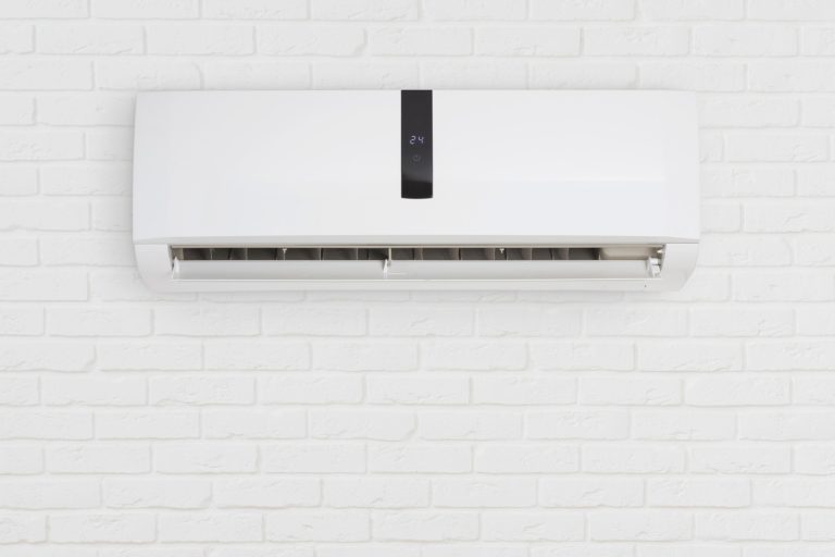 Split system air conditioning unit on decorative white brick wall - How To Know If An AC Is Inverter