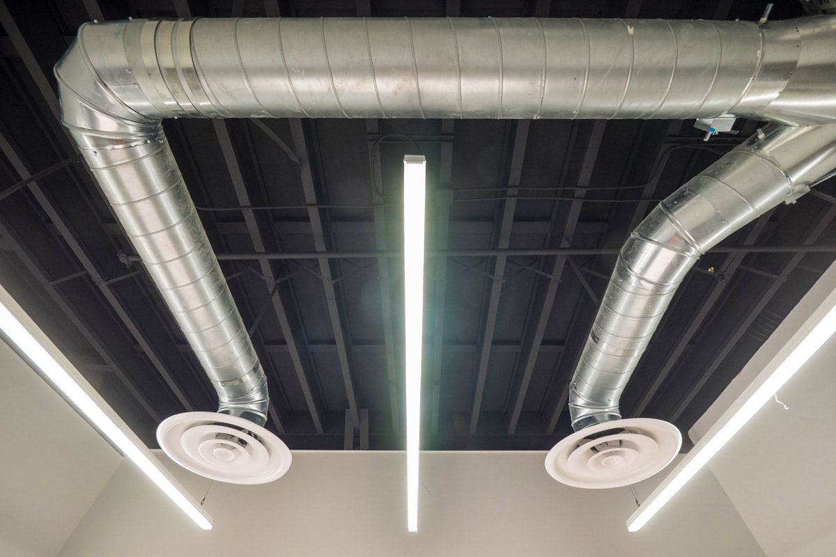 Stainless steel ductwork inside a small office room