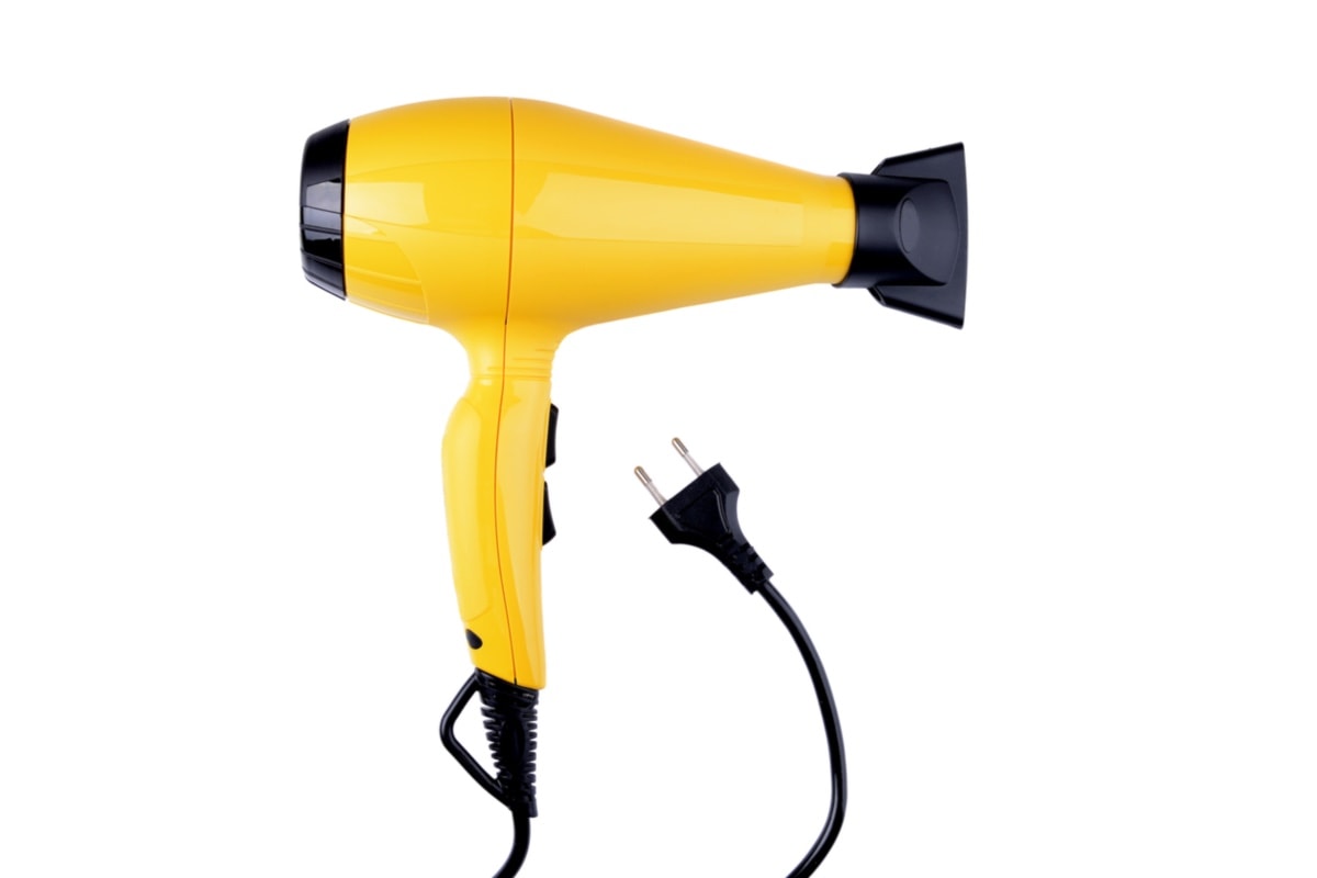 Using Hairdryer - yellow hairdryer on white background