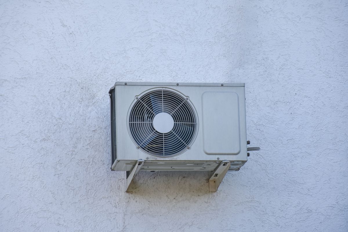 Wall mounted air conditioning unit on the wall of the house stock photo