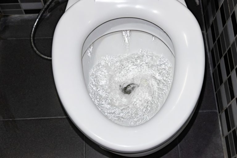Water flowing down the toilet in modern bathroom, Can A Running Toilet Increase Electric Bill?