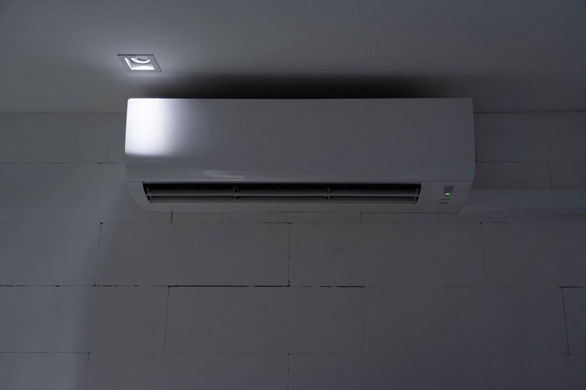 White split air conditioner on wall at night why dry mode is off