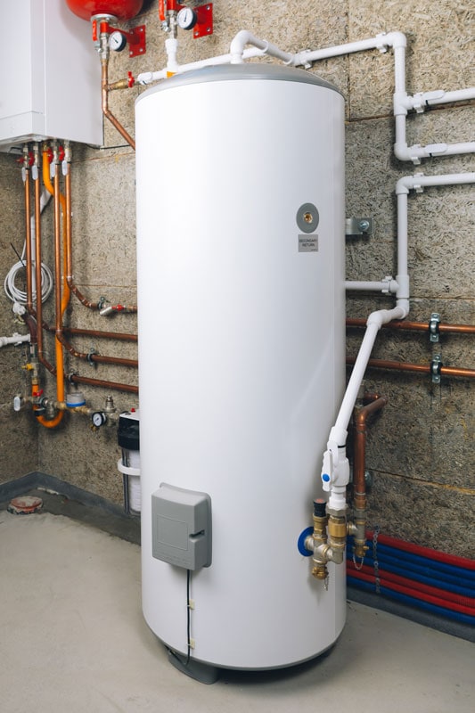 White tank water heater in modern boiler room