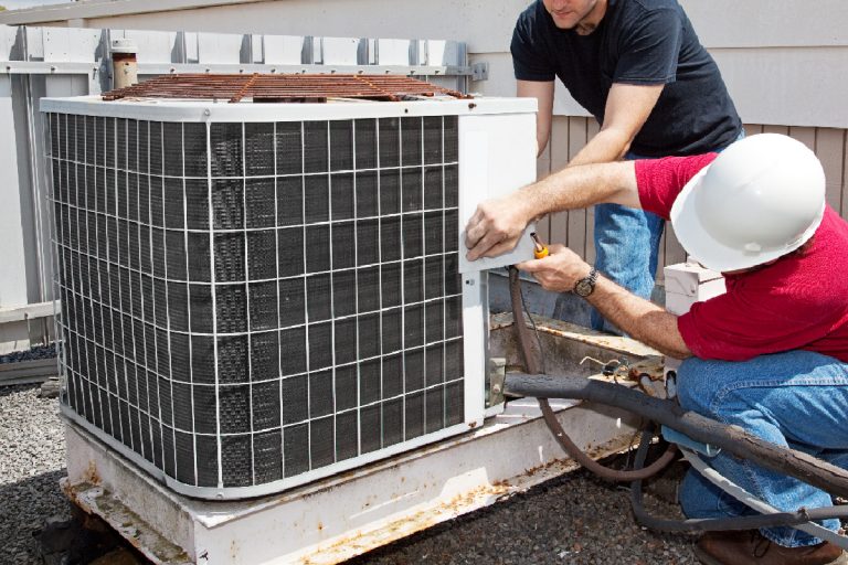 Workers in the roof of a building fixing the air conditioning unit, How To Fix Oil Logged Evaporator