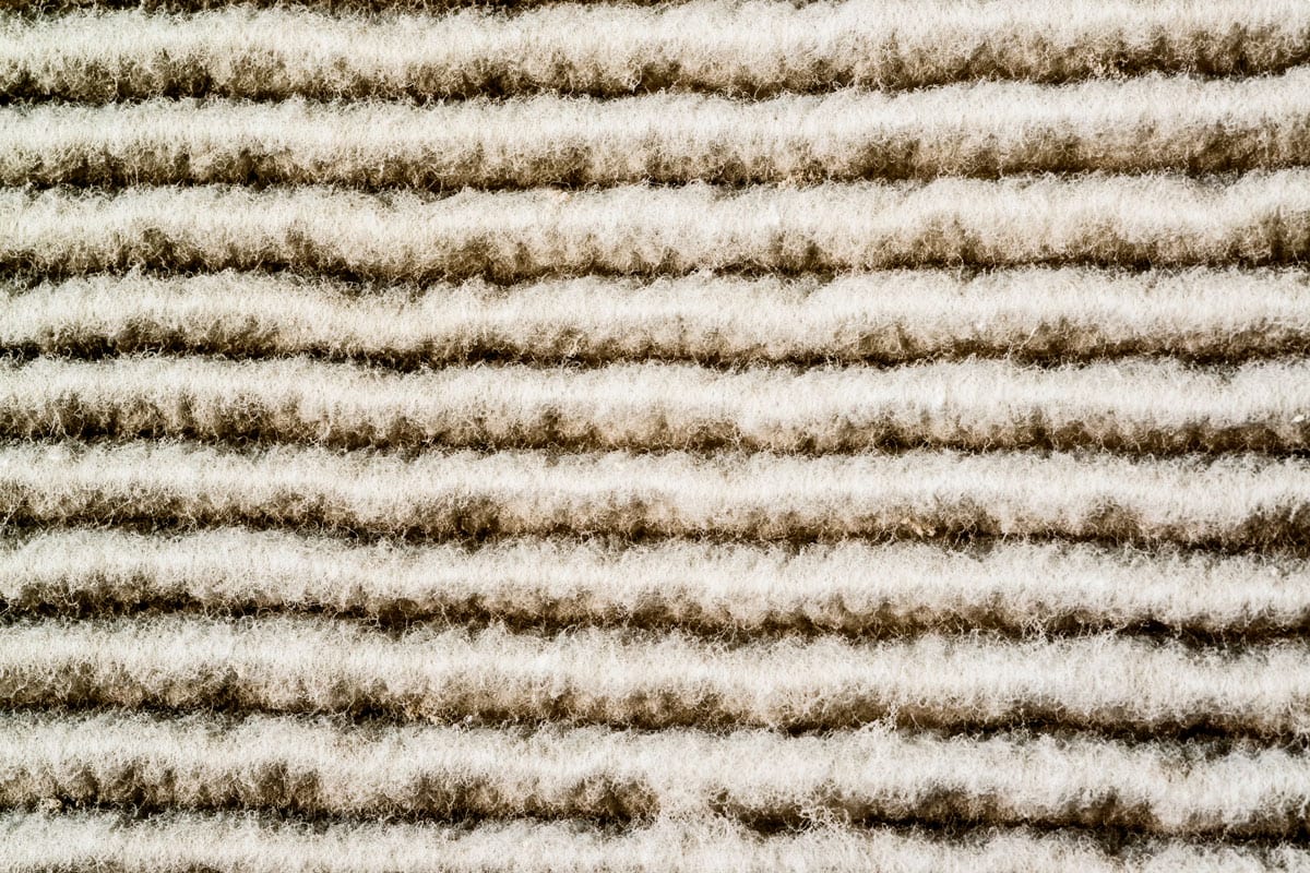 close up photo of a furnacace clogged up filter very dirty dusty