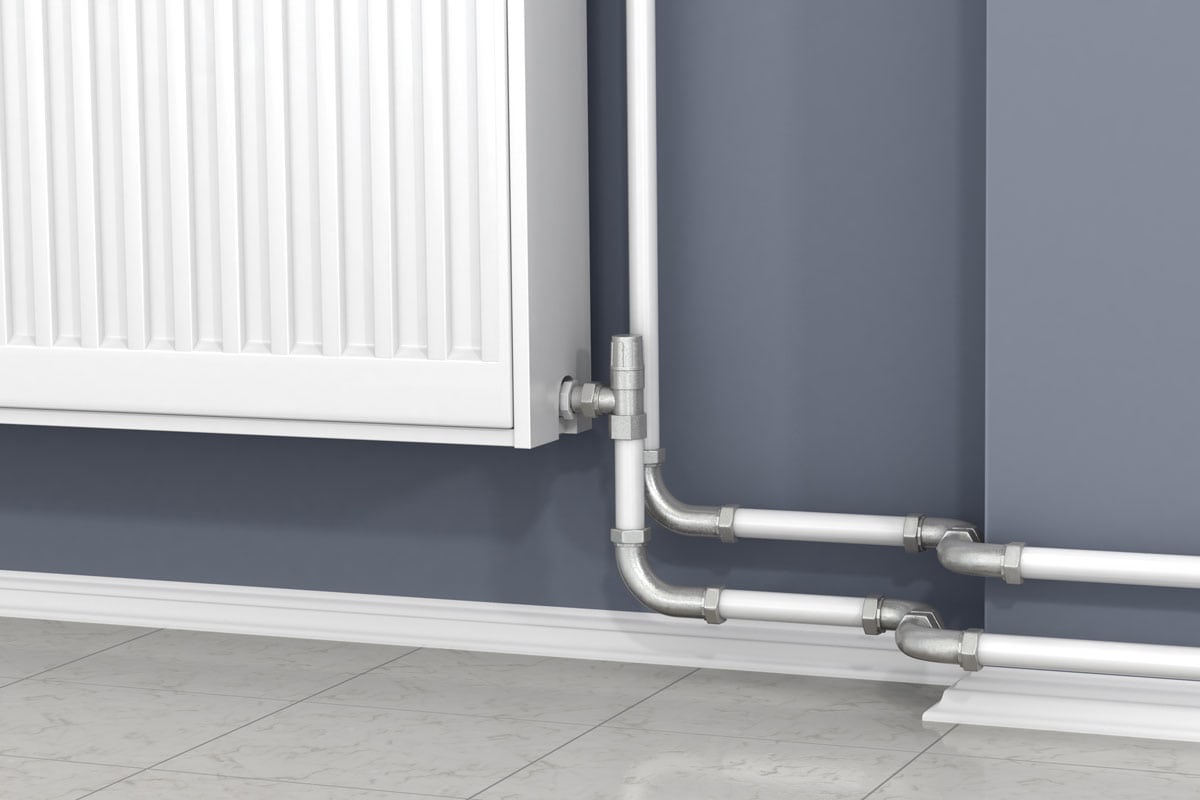photo of a baseboard heater mounted on the grey blue painted wall