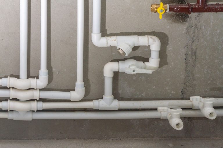 photo of a white pvc pipes on the basement of the house white water line pipes, Can PVC Pipes Sweat? [If So, How To Fix It?]