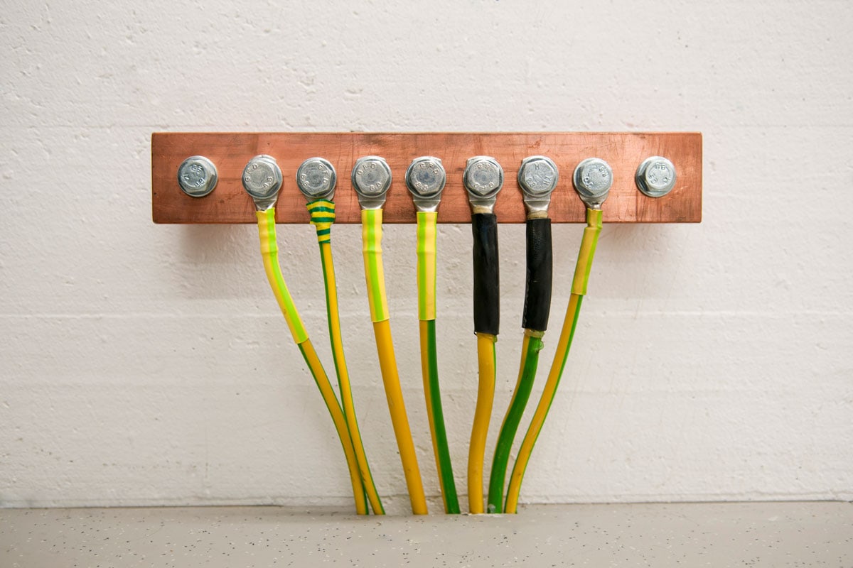 photo of an electrical high voltage ground copper bar installed on the wall