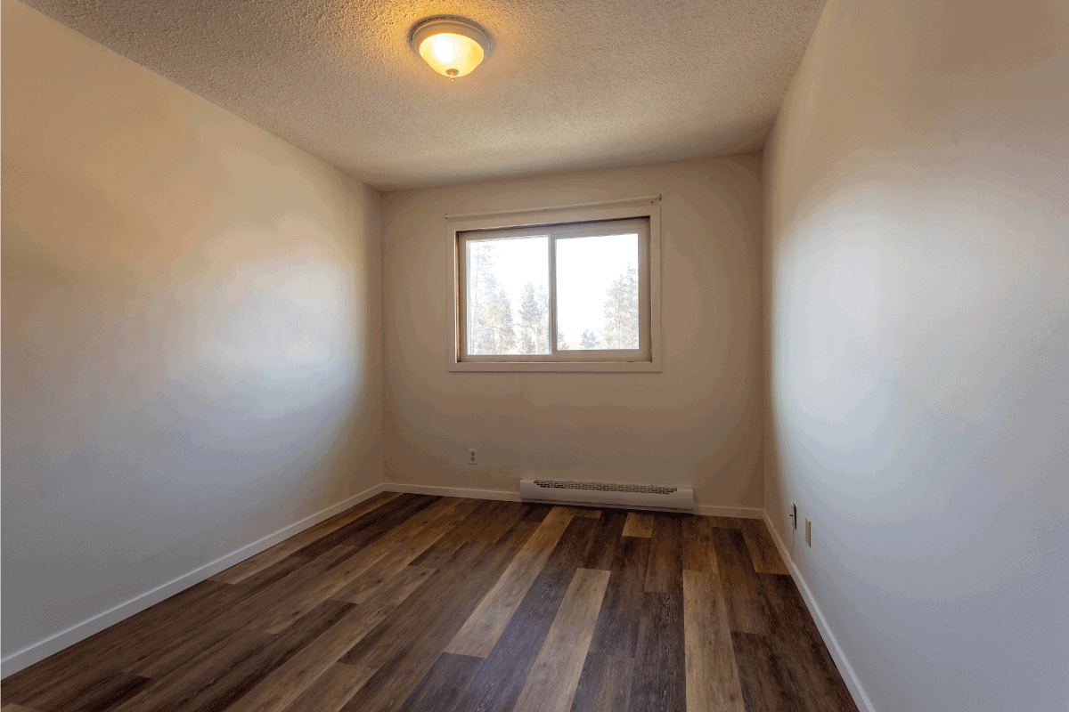 vacant rental apartment property with new hardwood laminate floors and baseboard heater. Are Baseboard Heaters Electric Or Gas