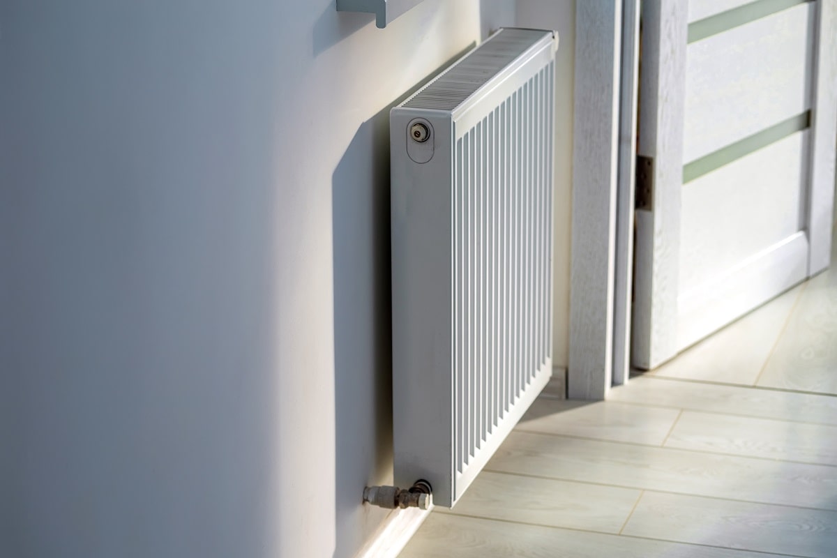 A steel panel heating radiator is placed under the windowsil