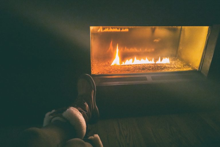 After ski resort woman wearing winter boots sitting by gas bio ethanol fireplace at night cozy fire place with flames glowing in the dark., How To Use The Battery Backup On My Gas Fireplace?