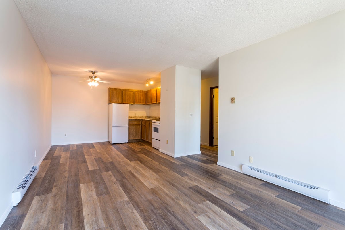 An empty vacant rental apartment property with new hardwood laminate floors and white paint on the walls