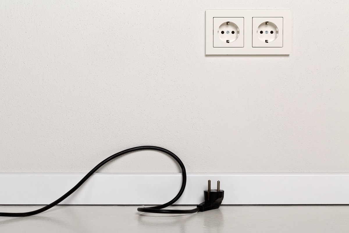 Blown Fuse Or Accidentally Unplugged Power Cord - Black power cord cable unplugged with european wall outlet