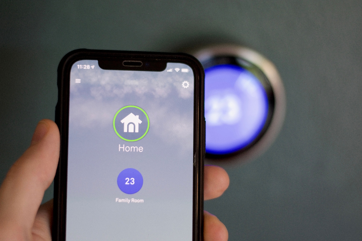 Cell phone adjusting temperature on Smart home thermostat