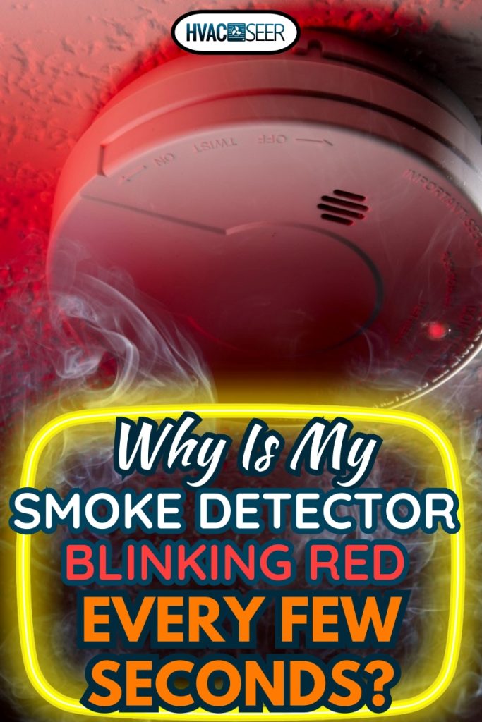Close up shot of ceiling mounted smoke detector with white smoke and red warning light, Why Is My Smoke Detector Blinking Red Every Few Seconds?