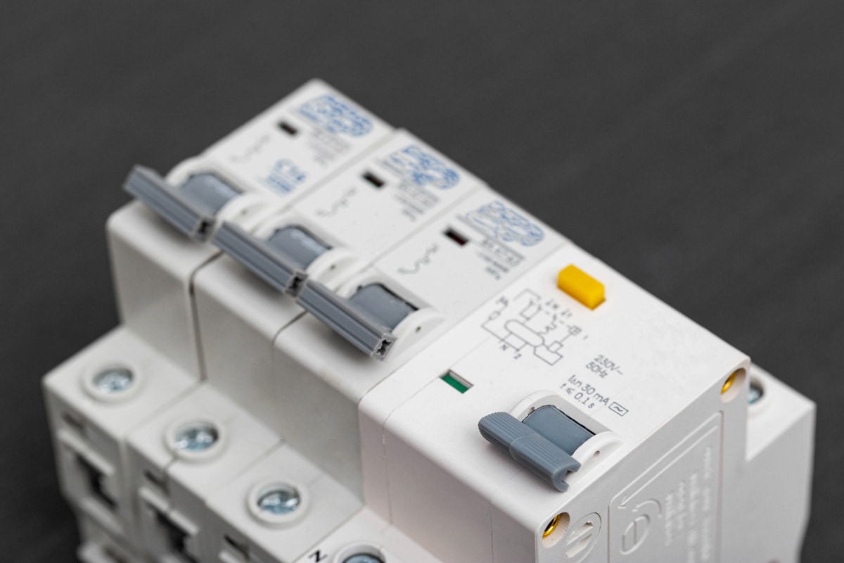 Electrical circuit breakers on a gray background, close-up.