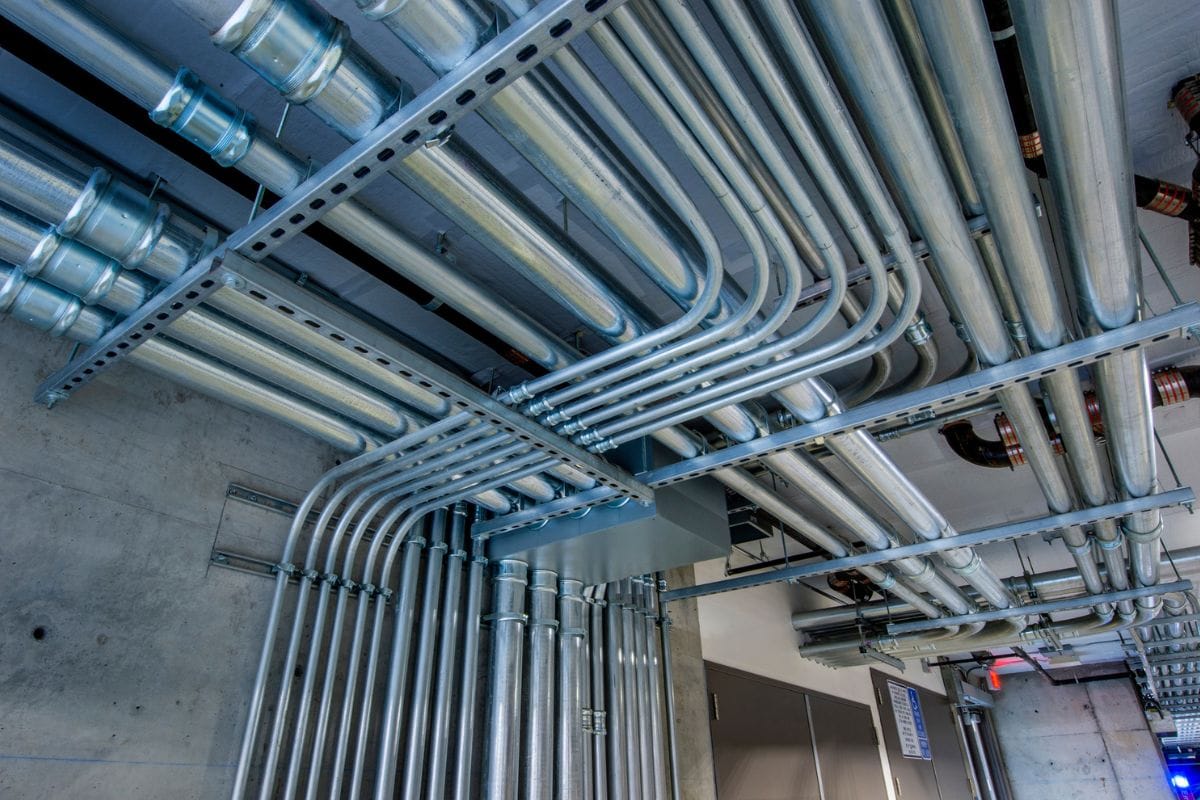 Electrical metal tubing and conduits in the ceiling of a commercial building.
