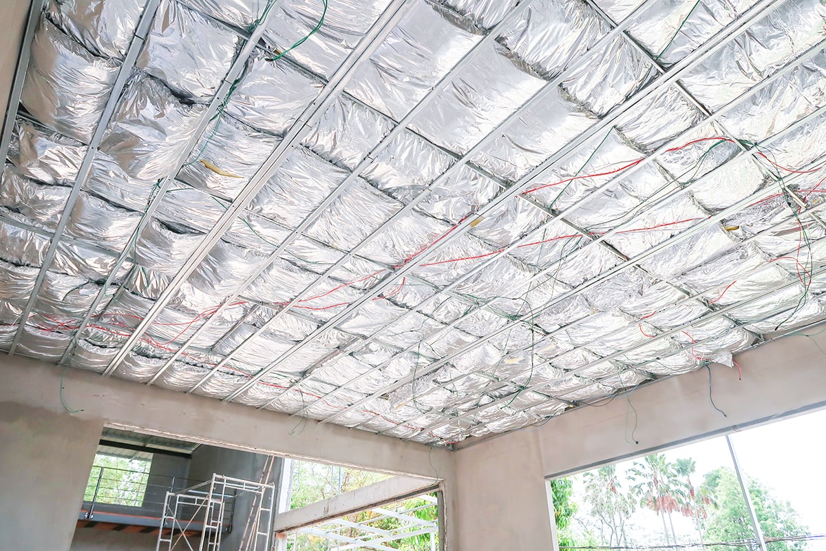 Home under construction install heat insulate ceiling in the form of foil