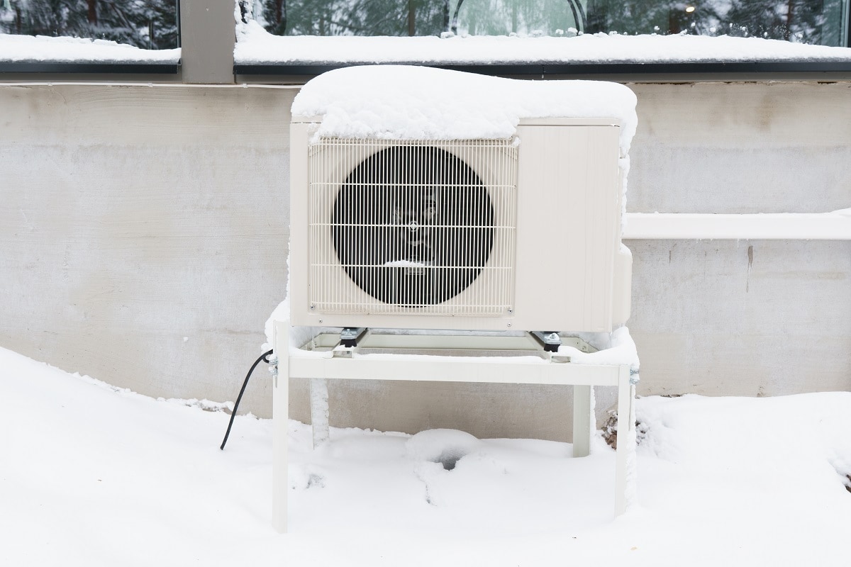 How Do You Deal With A Frozen Heat Pump In The Winter - The outdoor unit of an air-source heat pump after a winter storm.