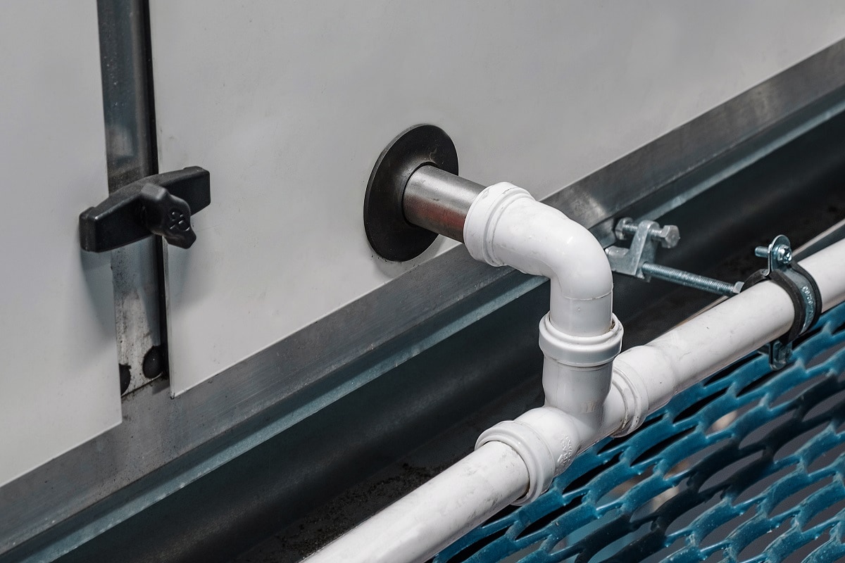 How To Clean Air Conditioner Condensate Line - Close-up view of the drainage pipeline connected to the industrial air handling unit