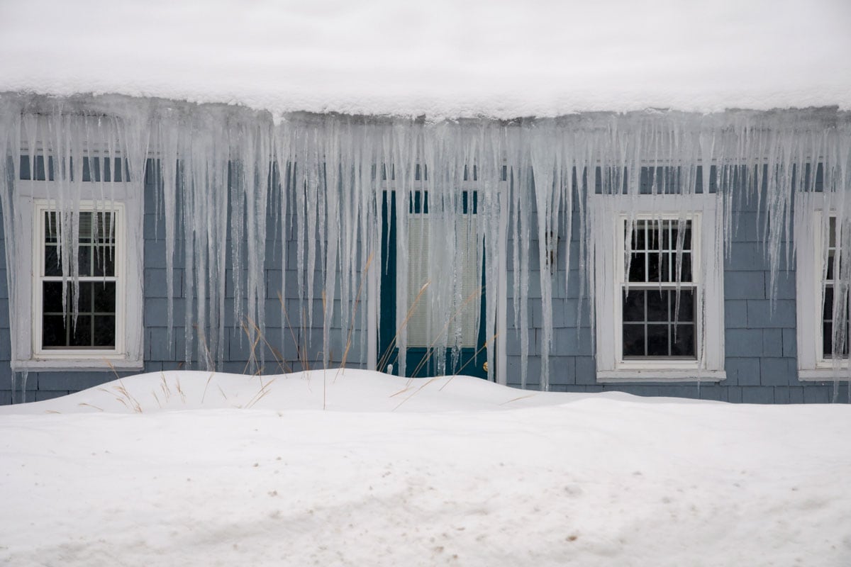 Icicles haging from ice dam roof in New England