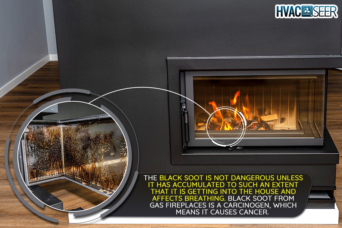 A burning wood in a modern fireplace with a closed combustion chamber, Is Black Soot From Gas Fireplace Dangerous? [What Homeowners Need To Know!]