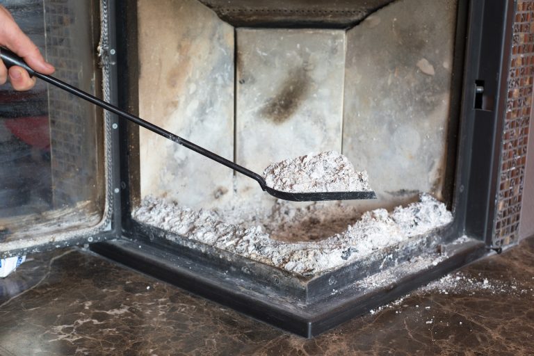 Man cleaning fireplace from ashes, How To Clean And Dispose Of Fireplace Ashes?