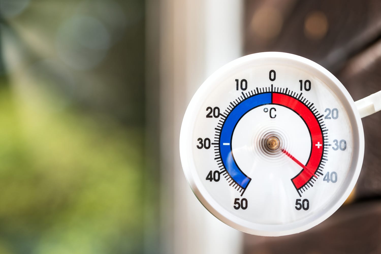 Outdoor thermometer with celsius scale shows extreme hot temperature 42 degree - summer heatwave concept