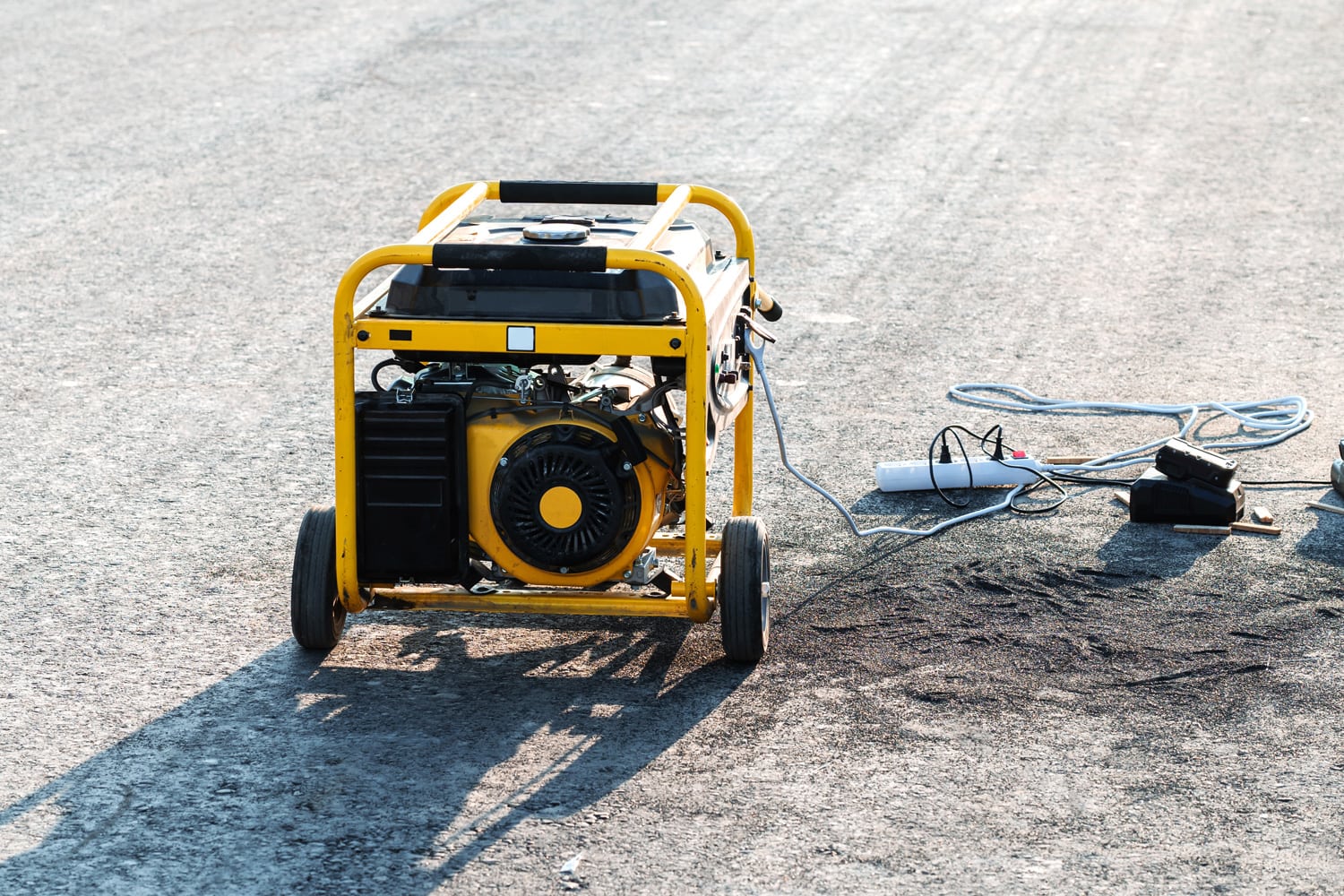Petrol power generator on small wheels. Portable equipment for power supply of construction sites and remote, hard-to-reach areas