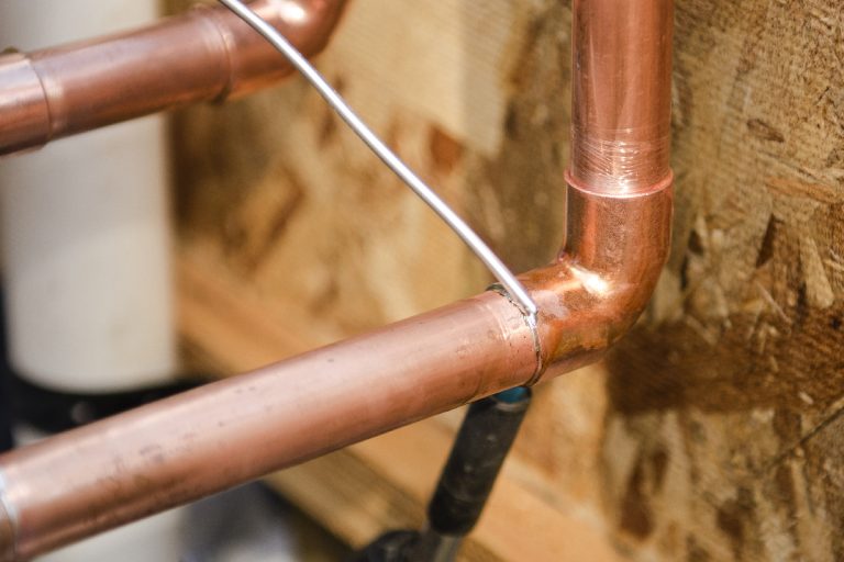A plumbing contractor sweating the joints on the copper pipe, How To Sweat Copper Pipe In Tight Spaces?