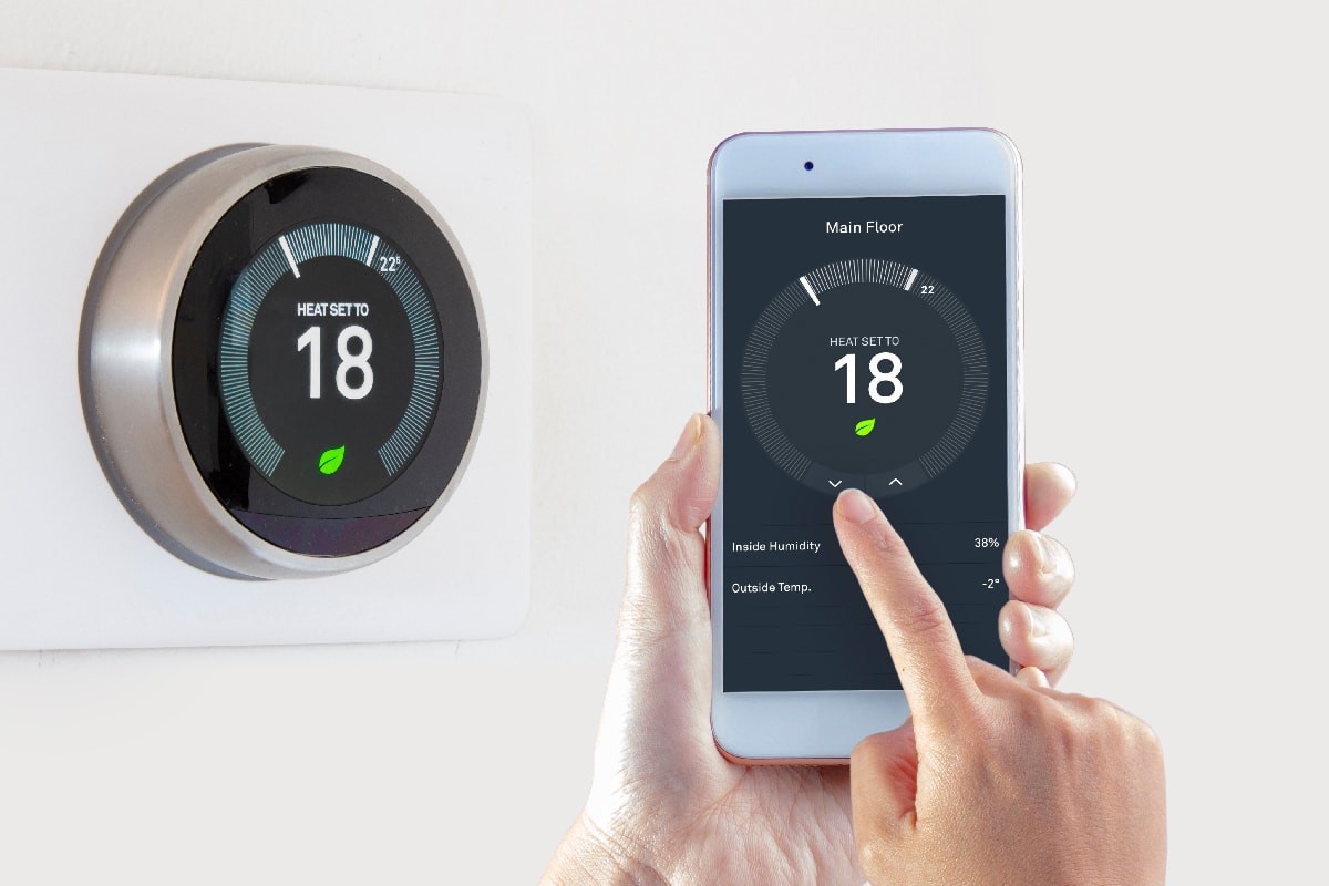Smart Thermostat with a person saving energy with a smart device