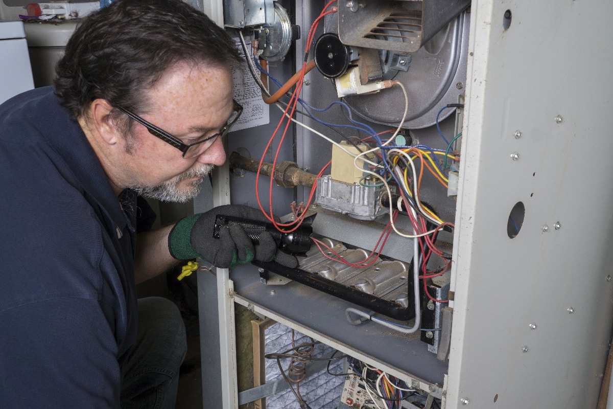 Technician looking over a gas furnace