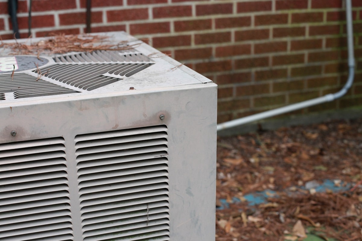 Wear And Tear - Air conditioning unit outside of red brick building