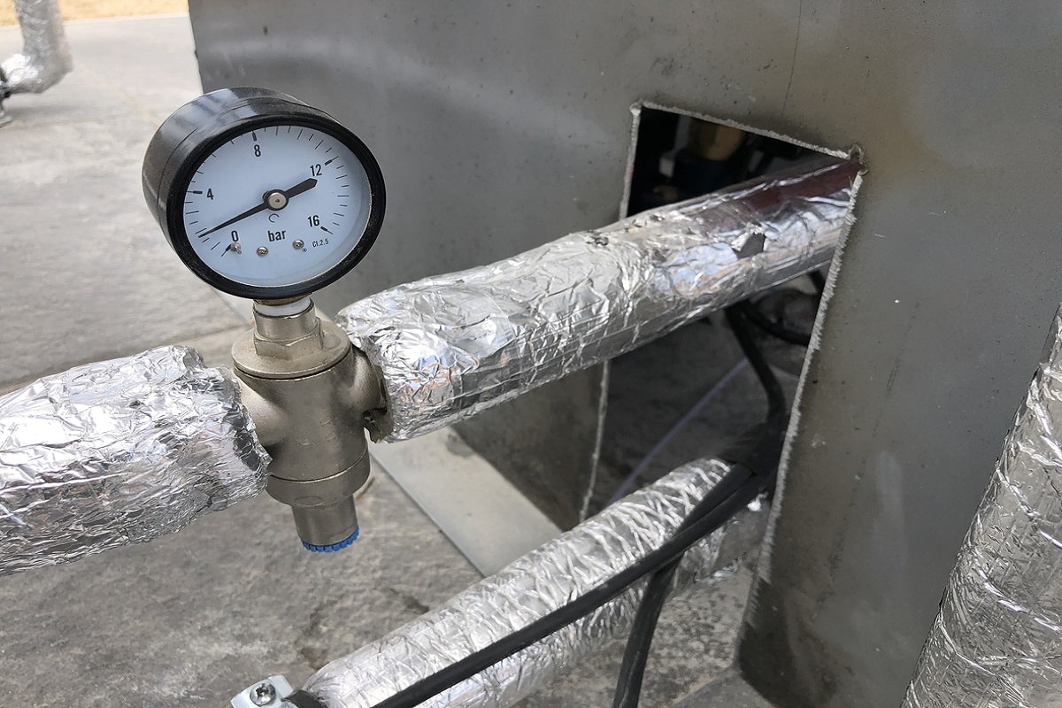 What Are Pipe Hangers - pressure gauge and thermally insulated pipes on the pipeline.