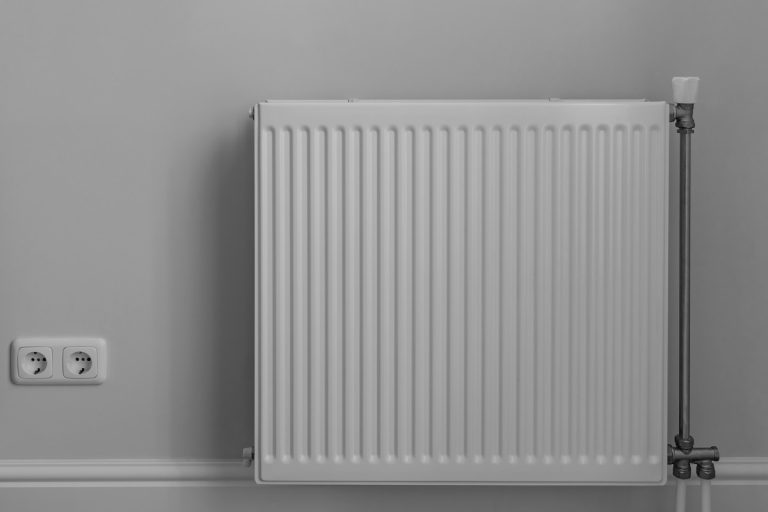 White steel panel heating radiator in the room, Why Does A Baseboard Heater Turn On By Itself?