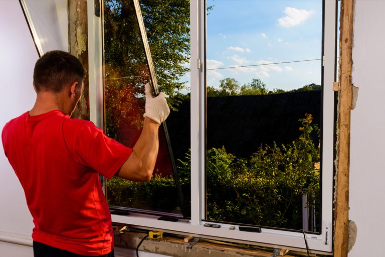 A worker insulation and installation on window, Materials needed to insulate windows from the outside