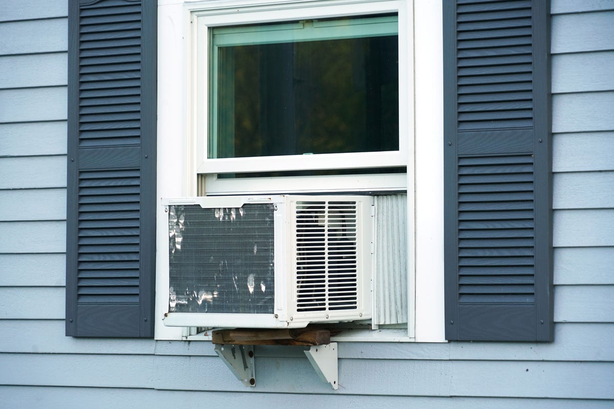 air conditioner installed on rustic house window