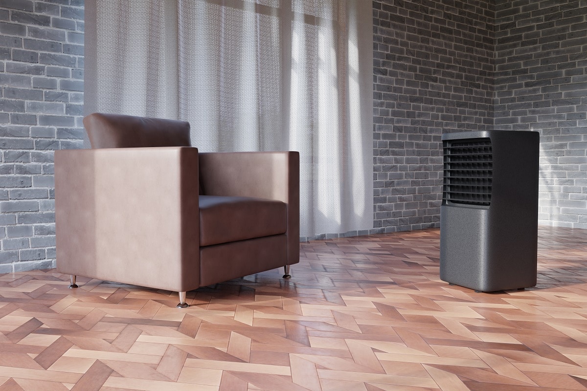 black portable air conditioner in the room next to the brown armchair
